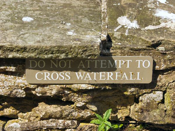 Sign saying: Do not attempt to cross waterfall